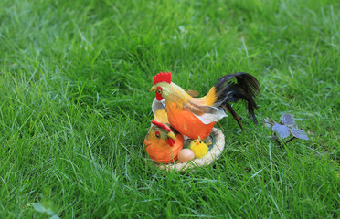 Fototapeta premium decorative rooster on the lawn