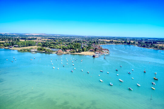 Aerial view over small boats and Sailing Dinghies anchored in the beautiful estuary at Bosham in Southern England. 