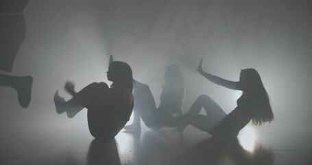 Lower angel of people dancing slowly in smoke