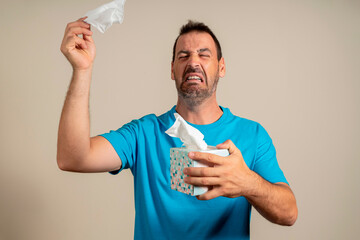 Sick and unhealthy allergic crying man has watery swelling, red eyes, runny nose, suffers from...