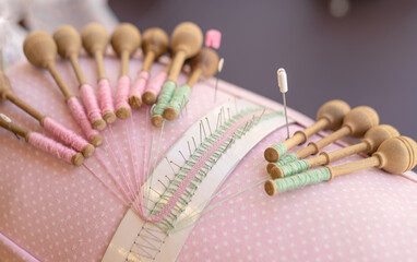 traditional portuguese Bobbin lace handcrafting. Close-up of threads and bobbins and needles...