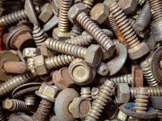 group of rusty screws in a box due to the passage of time.