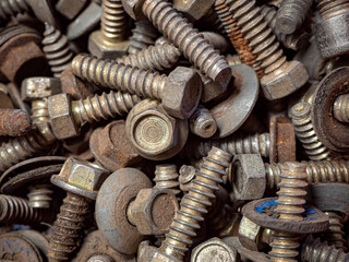 group of rusty screws in a box due to the passage of time.