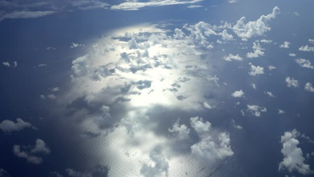 Shot of reflexion of early morning sun on the ocean and clouds above it