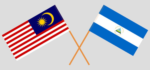 Crossed flags of Malaysia and Nicaragua. Official colors. Correct proportion