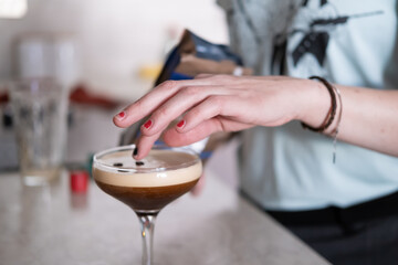 An unrecognizable person decorating cocktails at home