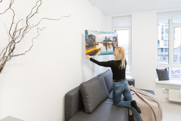 Photo canvas print. A woman holding a photography with gallery wrap. Photo printed on glossy...
