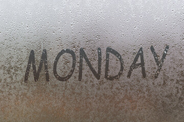 MONDAY written on the glass screen with raindrops background. Mood of working every start of the week.