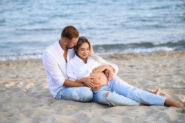 Pregnancy Happiness.Cute Family Moments, Parents-To-Be. Side View, Copy Space. Happy pregnancy woman and husband hugging pregnant belly. Concept of pregnancy, maternity, expectation for baby birth.