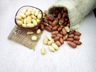       Peanuts in burlap bag on wooden table  