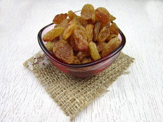      a bowl of yellow golden raisins                 