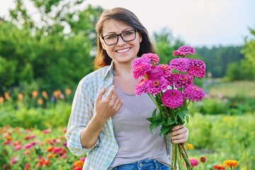 Portrait of a middle aged woman with a bouquet of flowers outdoor