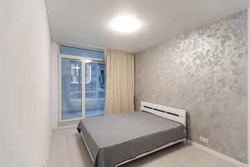 bed with two pillows. gray linen on king size bed. minimalism in hotel