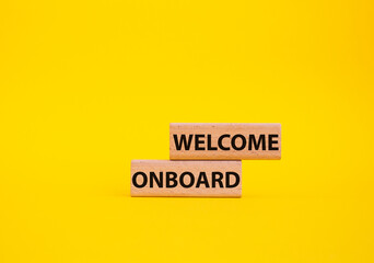 Welcome onboard symbol. Concept words Welcome onboard on wooden blocks. Beautiful yellow background. Business and Welcome onboard concept. Copy space.
