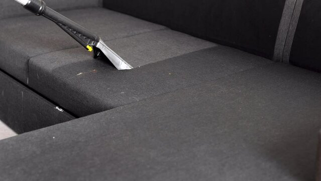 Cleaning sofa with water vacuum cleaner