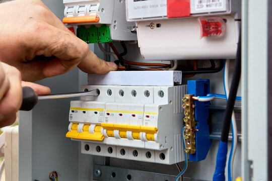 Electric distribution board consumer unit with fuse box or circuit breaker, electrical work to install new panel.