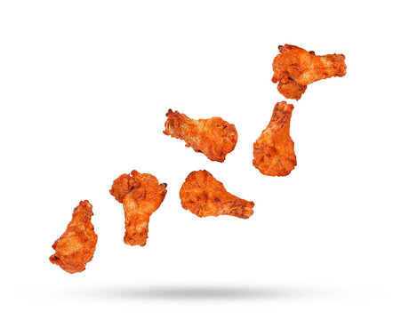 Barbecue chicken legs falling in the air isolated on white background.