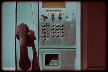 Old retro payphone standing street.