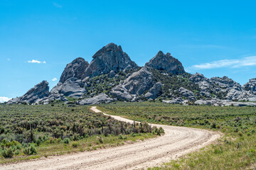 A dirt road leads to granite outcroppings at the City of Rocks National Reserve, Idaho, USA
