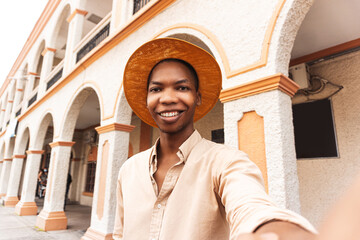 Happy young man millennial taking a selfie smiling at the camera near colonial city of honduras.