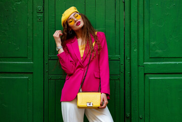 Fashionable confident woman wearing trendy outfit with yellow sunglasses, beret, wrist watch,...