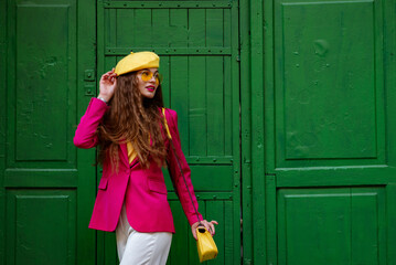 Fashionable happy smiling woman wearing trendy outfit with yellow sunglasses, beret, shoulder bag,...