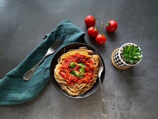 spaghetti with tomato sauce and basil, dark fabric