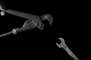 Gas and wrench on a black background