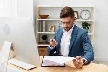 handsome businessman sitting at the computer work boss documentation isolated background