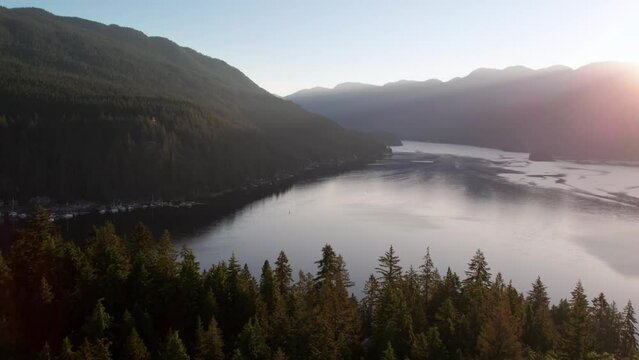 Aerial drone footage of Quarry Rock, Deep Cove, North Vancouver, BC, sunrise over mountains, boats. 4K 24FPS.