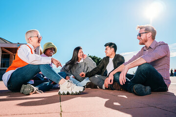 Fototapeta premium Group of friends sitting on floor laughing and having fun.