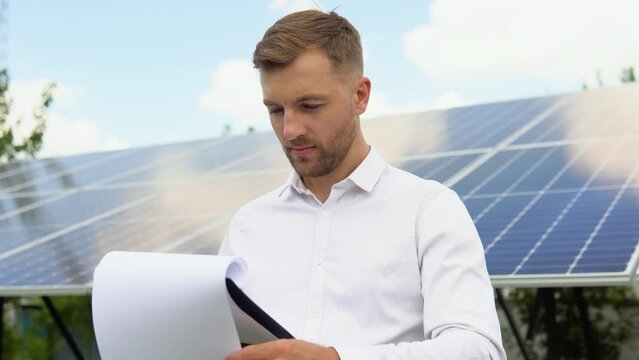 Engineers checking solar panels. Alternative energy ecological concept