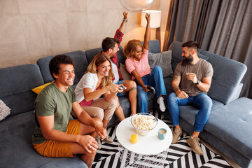 Friends playing video games at home