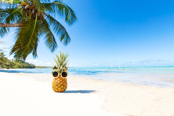 Funny pineapple face in funky glasses on vacation