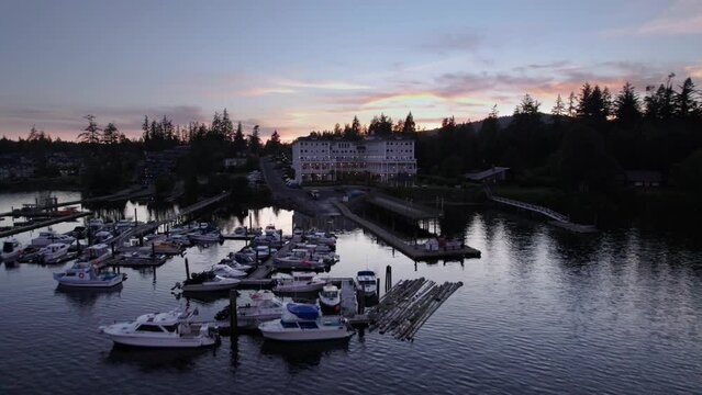 Aerial drone footage boats in harbour at sunset, Sooke BC, sail boats, marina, sunset sky. 5.4K TO 4K 24FPS.