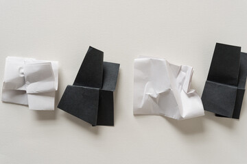 crumpled black and white paper on a blank surface