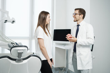 Female patient have a conversation with dentist in dental office