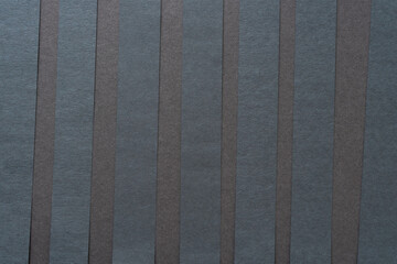 black paper stripes on dark gray paper board