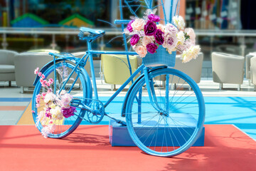 Fototapeta na wymiar Decorative vintage blue bicycle with flowers