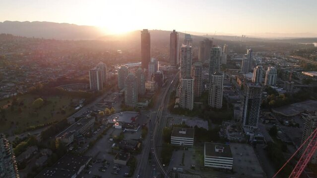 Aerial drone footage sunrise apartment buildings, sunrise skyscrapers, condominiums, real estate market Vancouver, Brentwood. 4K 4096X2304 24FPS PRORES 422