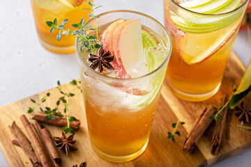 Refreshing apple cocktail or mocktail with ice and sliced apples