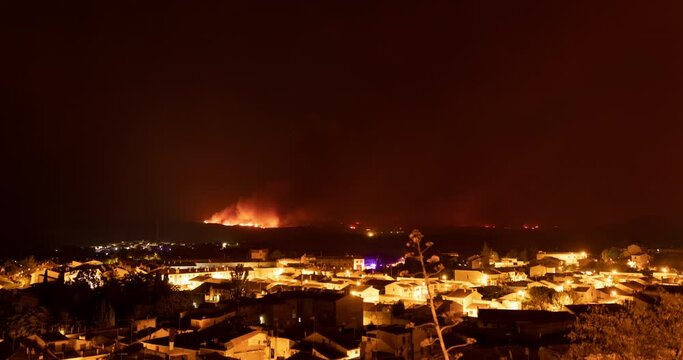 View of forest fire flames in the Moncayo area from Borja village, at night, devouring hills and trees with virulence, thanks to hurricane force winds and drought