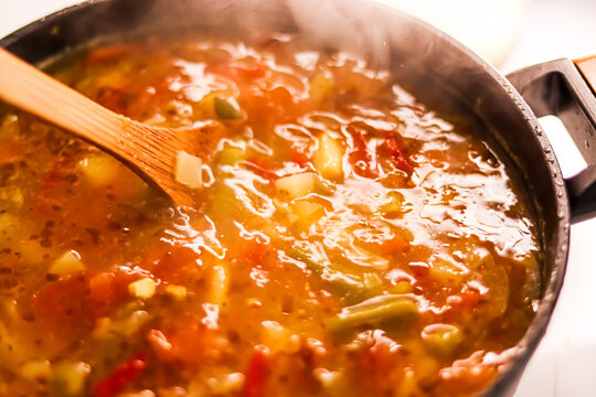 Cooking vegetable soup in saucepan, comfort food and homemade meal concept
