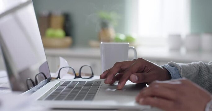 Entrepreneur hands typing on a laptop, as a black professional corporate business man is working closeup. African American sitting at office desk doing research for a company project