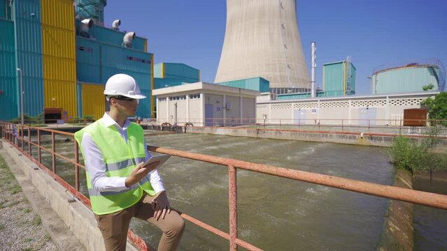 Natural gas processing plant.
Engineer inspecting the waste water pool inside the power plant.
