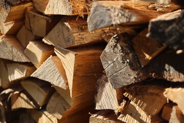 Stack of wooden logs prepared by farmers to overcome european energy crisis. Dried firewood in pile. 
