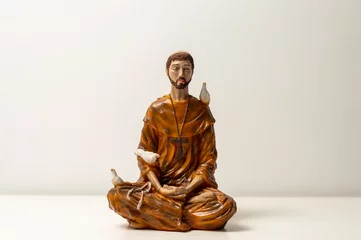 Deurstickers Statue of Saint Francis of Assisi. Statuette of Saint Francis of Assisi meditating. Padmasana pose. Lotus asana. Asana Padmasana © Otávio Pires