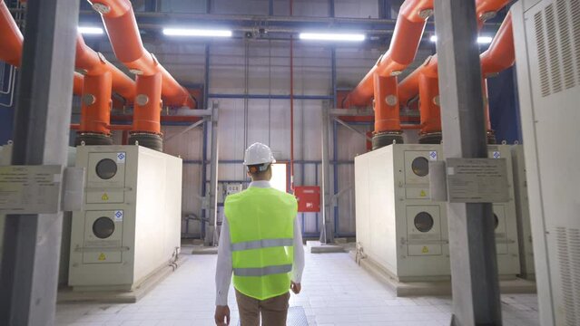 Nuclear power plant control panels.
The engineer is walking inside the power plant.
