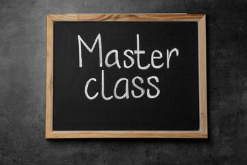 Obraz premium Blackboard with words Master Class on grey table, top view