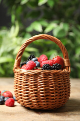 Mix of ripe berries on wooden table